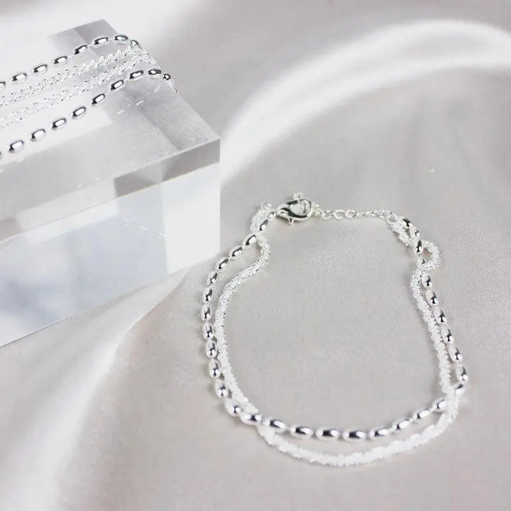 Elegant silver bracelet set with zirconium stones